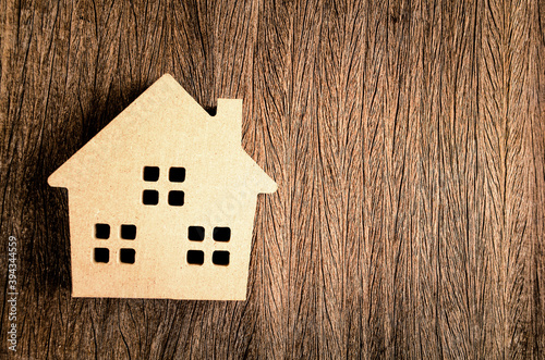 Wooden home model in vintage tone on wood background
