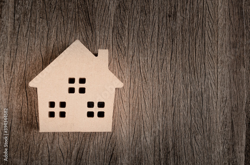 Wooden home model in vintage tone on wood background