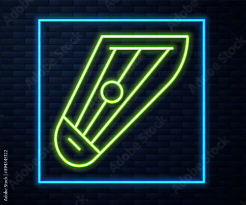 Glowing neon line Musical instrument kankles icon isolated on brick wall background. Vector.