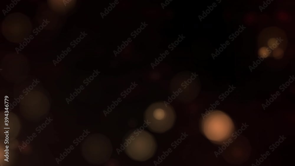 Elegant copy space as looped golden bokeh particles on dark background. Orange gold abstract luxury backplate as shining defocused dust bokeh glitter template with discreet glittering subtle overlay.