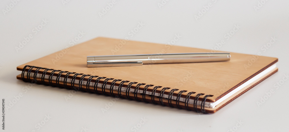 Blank note paper with pen. isolated on white.