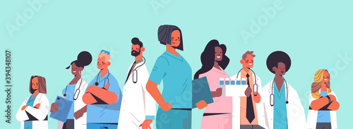 team of medical professionals mix race doctors in uniform standing together medicine healthcare concept horizontal portrait vector illustration