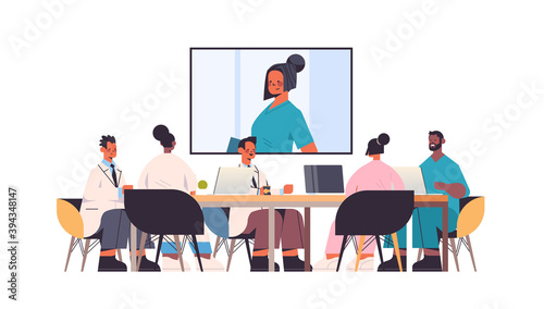 team of doctors having video conference mix race medical professionals discussing at round table medicine healthcare concept horizontal full length vector illustration