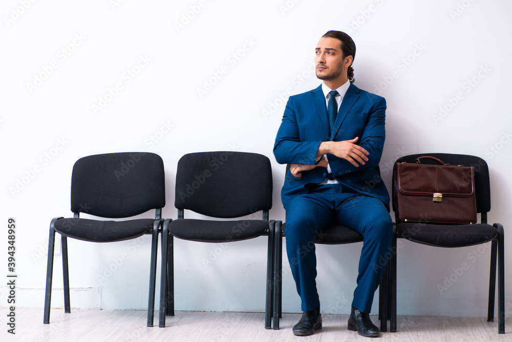 Young businessman waiting for an interview at hall Young businessman waiting for an interview at hall
