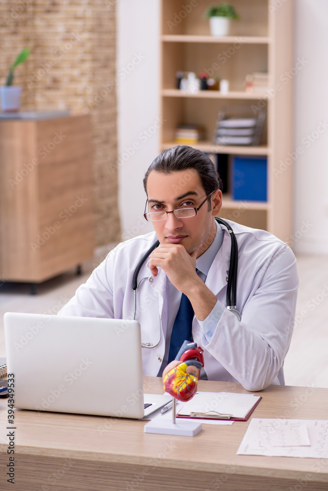 Young male doctor lecturer cardiologist working in the clinic Young male doctor lecturer cardiologist working in the clinic