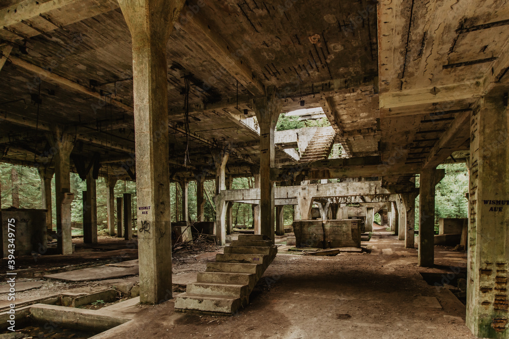 View of abandoned empty buildings of old tin mine. Industrial dirty building interior. Damaged factory in Rolava, Ore mountains,Czech republic