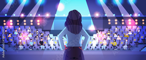 rear view female doctor giving speech at medical conference with people in masks medicine healthcare coronavirus quarantine concept lecture hall interior horizontal vector illustration