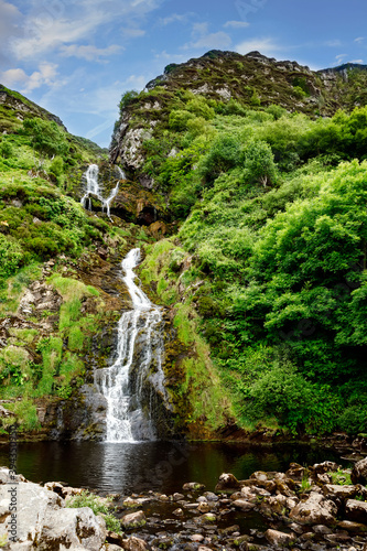 Fototapeta Naklejka Na Ścianę i Meble -  Beautiful water cascade of Powerscourt Waterfall, the highest waterfall in Ireland. Famous tourist atractions in co. Wicklow, Ireland. Near Powerscourt Manor House