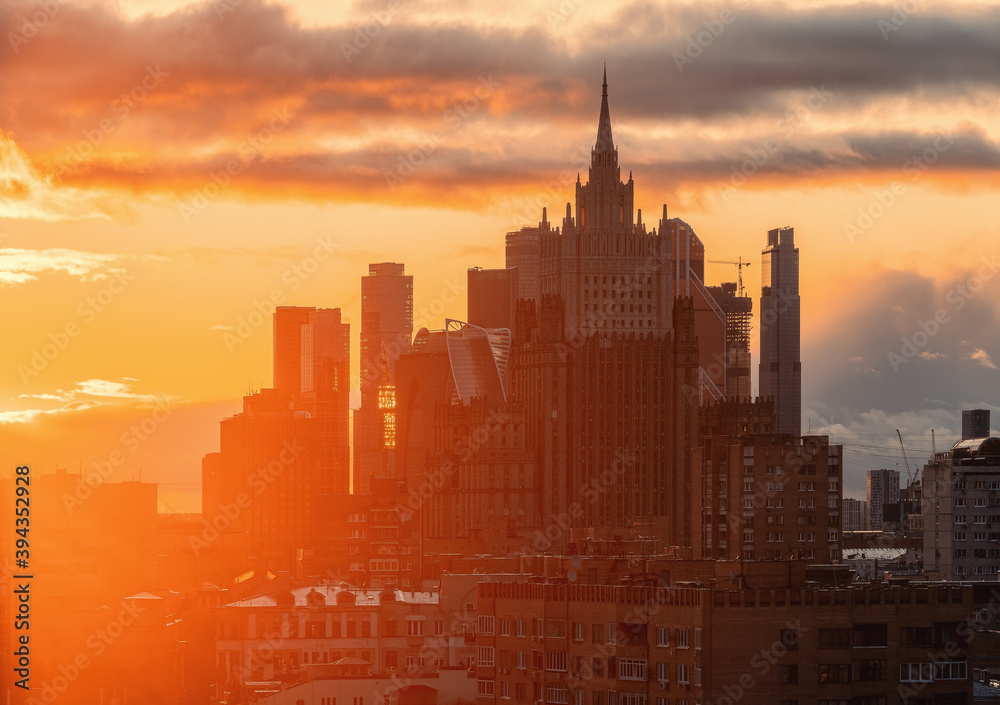 City landscape during a fiery sunset. View of the Ministry of Foreign Affairs and the buildings of the Moscow City business center from the observation deck of the Cathedral of Christ the Savior.