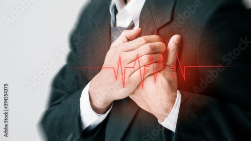 business man clutching his chest from acute pain. Severe heartache, a man suffering from chest pain, having a heart attack or painful cramps, pressing on chest with a painful expression.