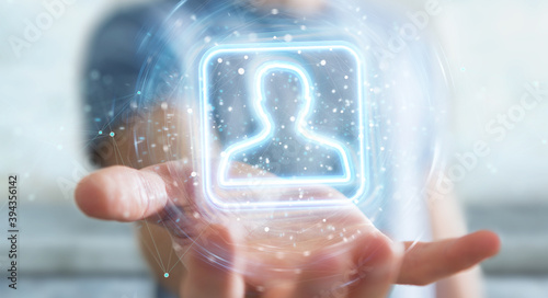 Photos Man using digital blue holographic user interface 3D rendering