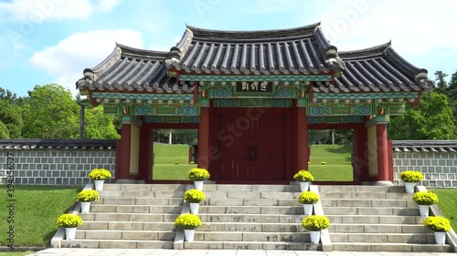 Scenic Gate Through The Peaceful Garden Of Iconic Tomb Of Seven Hundred Patriots In Geumsan, Chungcheongnam-do, South Korea - Medium Shot (Backward) photo