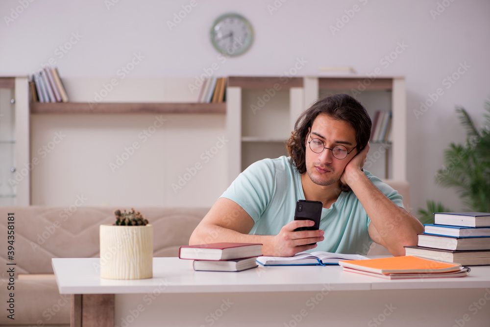Young male student preparing for exams at home Young male student preparing for exams at home
