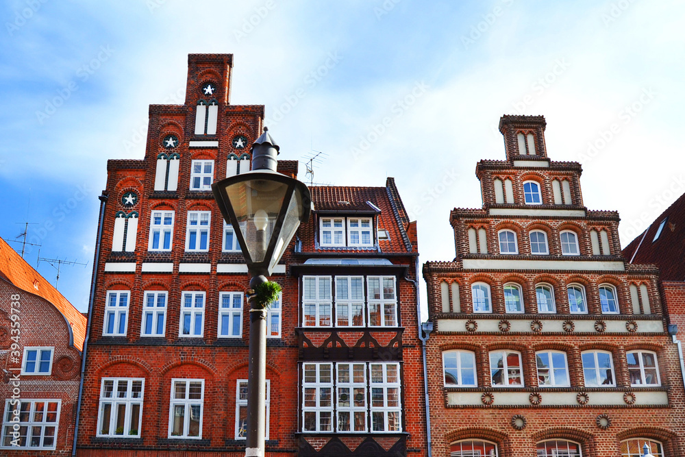 Old brick buildings with lantern on foreground, Luneburg, Germany, Europe. Brick gothic architecture.