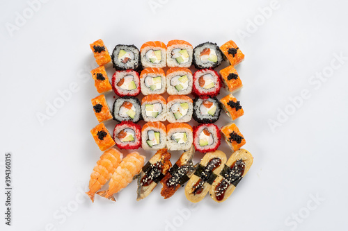 Large set of different types of sushi maki and nigiri on a neutral light background