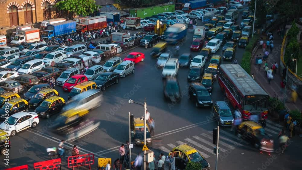 Time lapse view of rush hour traffic at busy intersection in Mumbai, Maharashtra, India. 