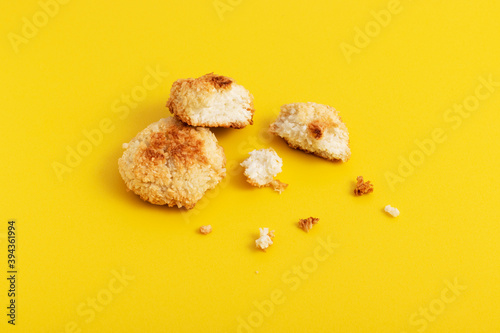 Homemade dietary sugar-free coconut cookies on yellow background.