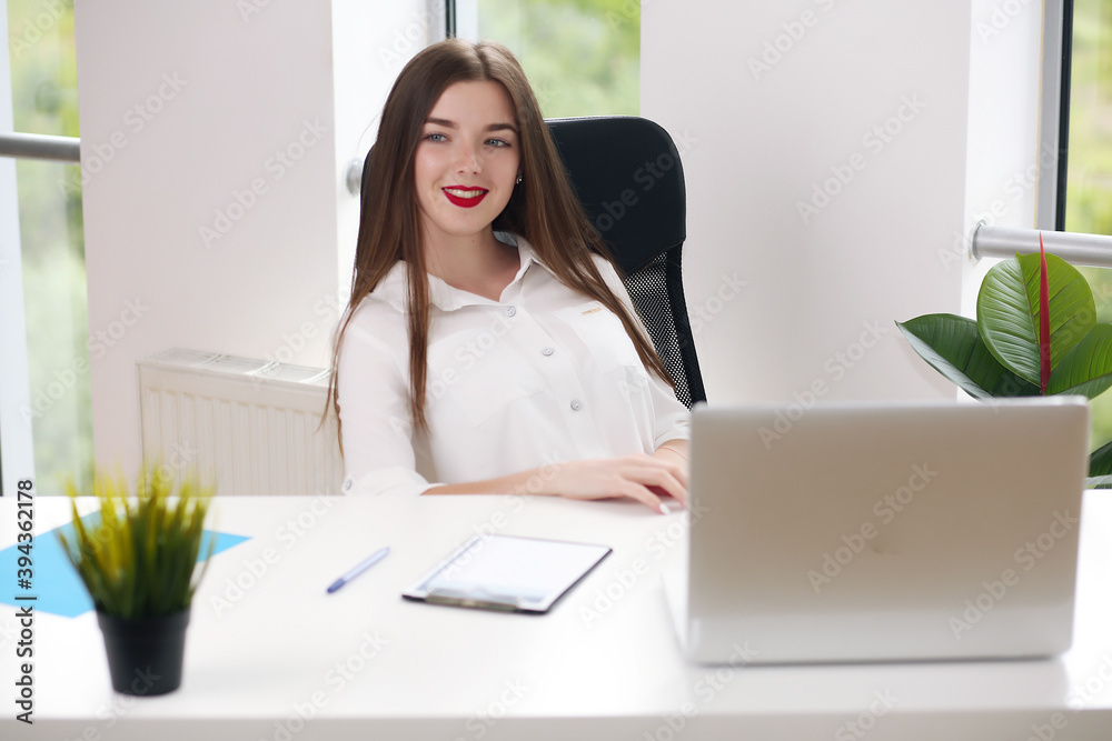 young female student sitting in the office solving problems young female student sitting in the office solving problems