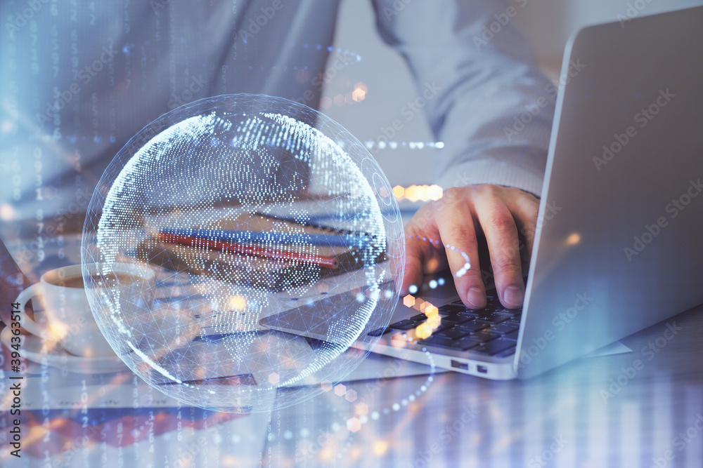 Double exposure of world map hologram with man working on computer on background. Concept of worldwideweb. Double exposure of world map hologram with man working on computer on background. Concept of worldwideweb.
