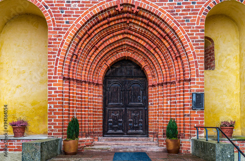 Extremely vaulted entrance door to an old brick church in Sweden