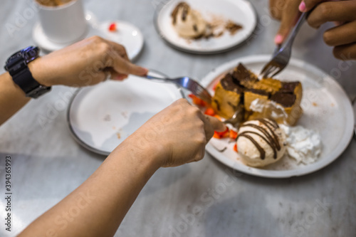 Blurred background view Of the dessert menu (Honey Toast) that contains ice cream, whipped cream, sour fruit like strawberries to be decorated and served to the customer.