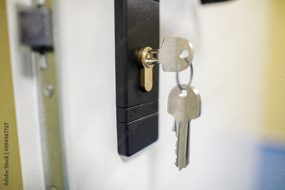 Shallow depth of field (selective focus) image with metal keys into a door lock. Shallow depth of field (selective focus) image with metal keys into a door lock.