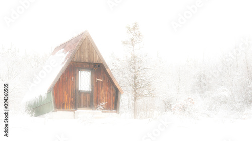 An abandoned cabin in foggy and snowy morning. © Bratislav Kostic