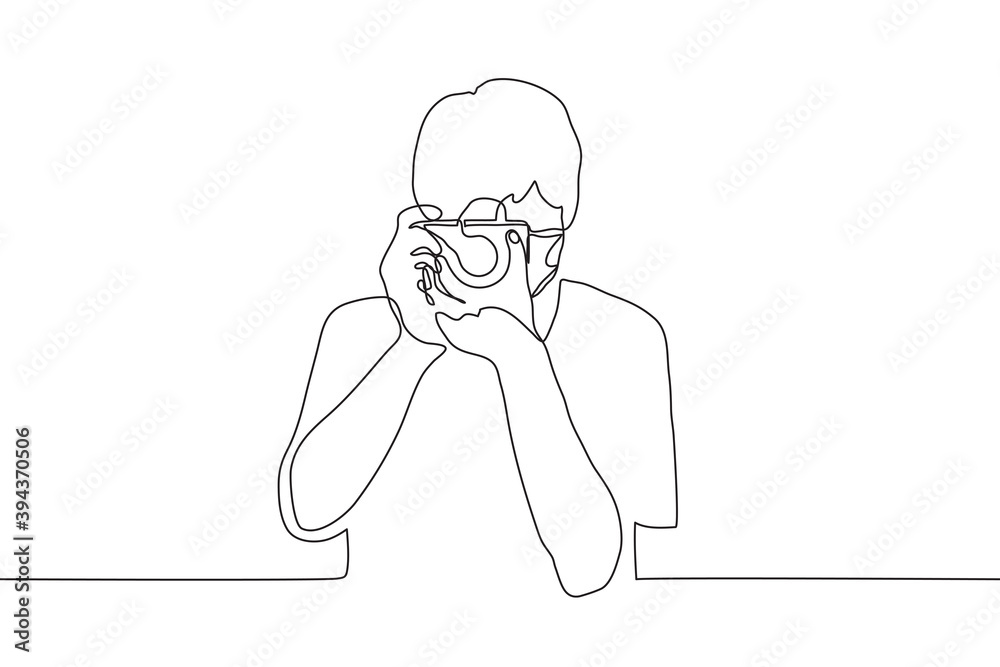 masked photographer holds a professional camera aimed at the viewer. one line drawing professional photographer makes a photo observer.