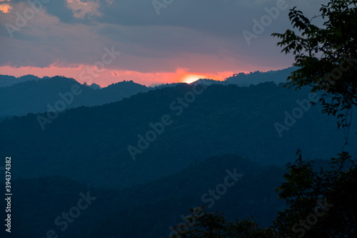 Sun-set moment, the scenery of mountains in layers, dark violet purple, and blue silhouette panoramic view