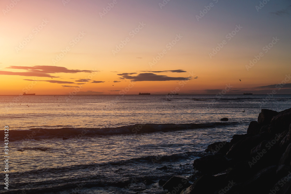 Sea rocks and blue sea and sunrise in Odessa on the beach