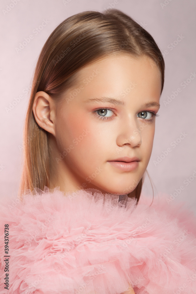 Young beautiful woman with perfect skin on pink background
