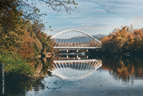 white bridge reflections over the romantic river at autumn 2