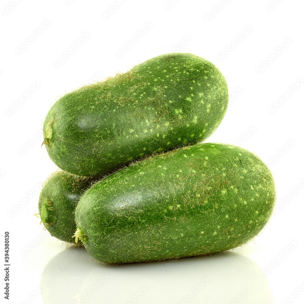 Three green zucchini(hairy squash) on a white background Three green zucchini(hairy squash) on a white background
