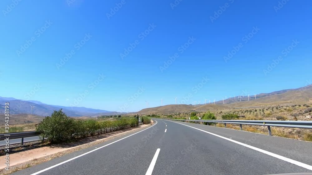 driving on highway between wind power turbines in desert mountains, Almeria, Andalusia, Spain
driving on highway between wind power turbines in desert mountains, Almeria, Andalusia, Spain