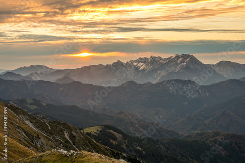 Spectacular mountain view of sun rising above high ridge in the distance. © anzebizjan