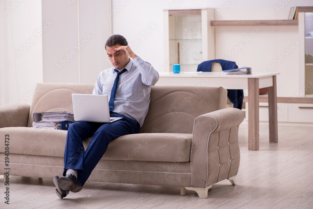 Young male employee working from home in pandemic concept Young male employee working from home in pandemic concept