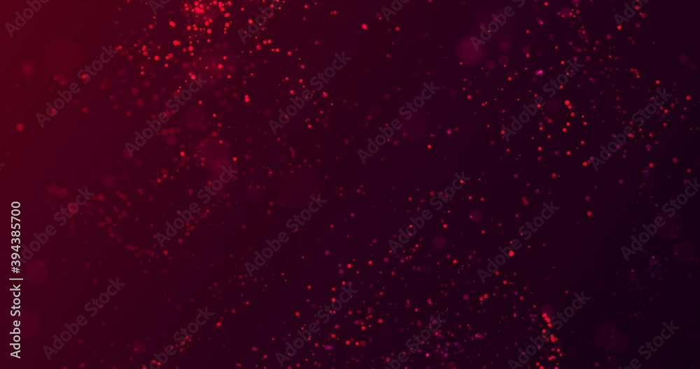 Red, magenta translucent particles with bokeh effect flicker and fly smoothly, chaotically on a gradient burgundy background