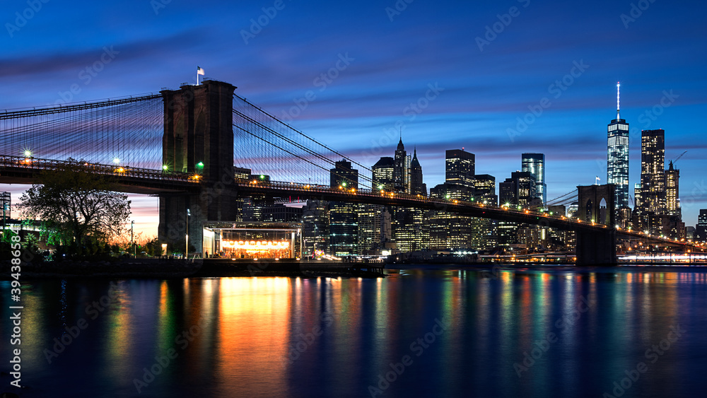 A landscape view of the Brooklyn Bridge as well as New York City.