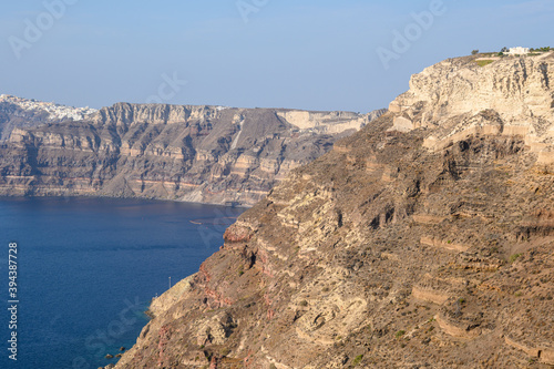 The coast of Santorini Island in Greece, impressive volcanic cliffs viewed from Megalochori village. Cyclades Island
