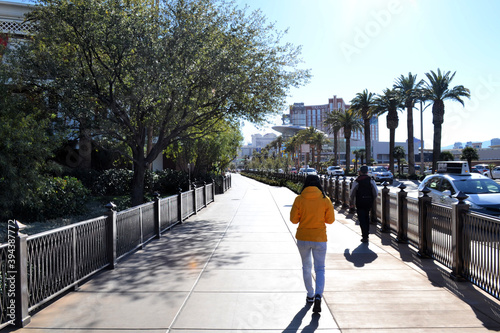 Woman in yellow jacket walking around Las Vegas, Nevada, US photo