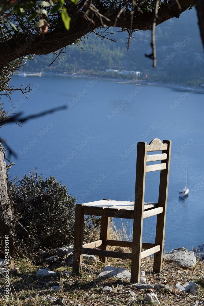 Wooden chair standing in front of a beautiful mountain landscape