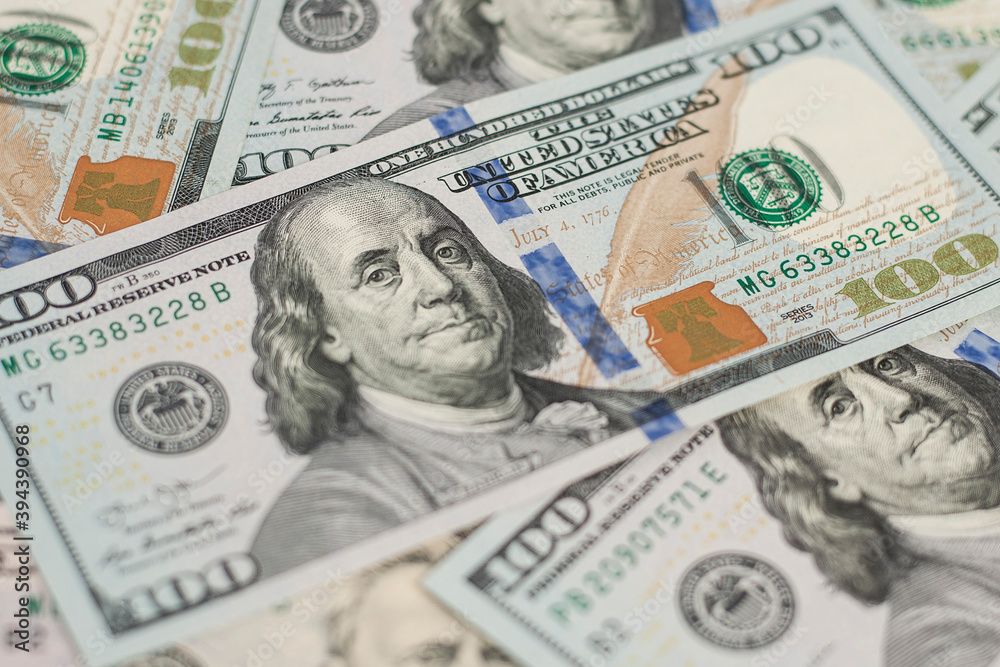100 Dollars bill and portrait Benjamin Franklin on USA money banknote. Hundred dollar bills on wooden background.. 100 Dollars bill and portrait Benjamin Franklin on USA money banknote. Hundred dollar bills on wooden background..