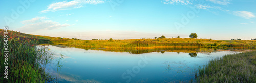 Tranquil summer landscape with river at sunset