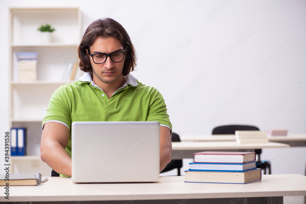 Young male student in the classroom Young male student in the classroom