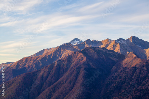 Krasnaya Polyana, Sochi, the mountains of the North Caucasus, snow-capped peaks against the background of autumn trees,