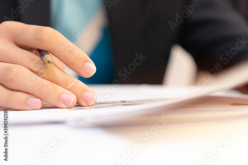 Businessman manager signing Document report and business note in meeting room concept: Start up writing for reading and learning in paperwork or documentation files at corporate office background.