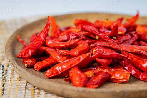 Dry chillies in wooden bowl on table closeup shots