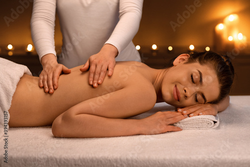 Woman having body massage session at modern spa