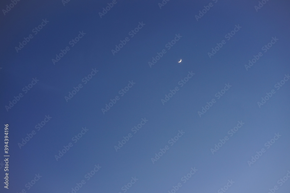 Crescent moon with empty blue sky copy space for banner or wallpaper background Crescent moon with empty blue sky copy space for banner or wallpaper background