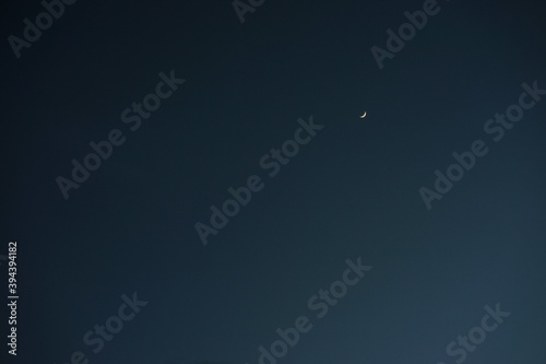 Crescent moon with empty blue sky copy space for banner or wallpaper background